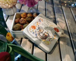 Fundraiser cookies in an illustrated tin for the Jane Goodall Institute Japan